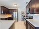 Spacious kitchen featuring stainless steel appliances, dark cabinetry, and light countertops at 434 E Harding St, Orlando, FL 32806