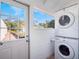 Laundry room with stacked washer and dryer and an exterior door with a view to the outdoors at 434 E Harding St, Orlando, FL 32806