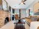 Inviting living room with a brick fireplace, ceiling fan, and cozy furniture at 434 E Harding St, Orlando, FL 32806