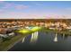 Aerial view of a well-planned community with a large pond, playground, and swimming pool at 5278 Walnut Ridge Dr, Orlando, FL 32829