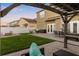 Spacious backyard with a paved patio, pergola, fire pit, and lush green lawn, perfect for outdoor gatherings at 5278 Walnut Ridge Dr, Orlando, FL 32829