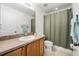 Functional bathroom featuring a vanity sink, toilet, and shower with a clean, neutral color palette at 5278 Walnut Ridge Dr, Orlando, FL 32829