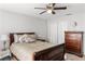 Comfortable bedroom featuring light gray walls, a ceiling fan, and a dresser for ample storage at 5278 Walnut Ridge Dr, Orlando, FL 32829