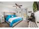 Comfortable bedroom featuring a ceiling fan, large windows, and a modern workstation at 5278 Walnut Ridge Dr, Orlando, FL 32829