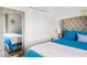 Bright bedroom features light gray walls, closet space, and a large mirror, enhancing the room's appeal at 5278 Walnut Ridge Dr, Orlando, FL 32829