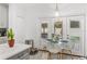 Bright dining area with a glass table, white chairs, and views of the outdoor patio at 5278 Walnut Ridge Dr, Orlando, FL 32829