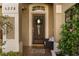 Close-up of the front door with glass accents, decorative wreath, and tiled entryway at 5278 Walnut Ridge Dr, Orlando, FL 32829