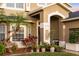 Inviting front entrance with well-maintained landscaping, columns, and a charming front door at 5278 Walnut Ridge Dr, Orlando, FL 32829