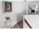 Upstairs hallway with gray carpet leading to a doorway with a view of a light and airy bedroom at 5278 Walnut Ridge Dr, Orlando, FL 32829