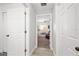 Hallway featuring several doors and an entry to another room at the end of the hallway at 5278 Walnut Ridge Dr, Orlando, FL 32829