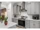 Modern kitchen showcases stainless steel appliances, marble countertops, gray cabinets, and tile backsplash at 5278 Walnut Ridge Dr, Orlando, FL 32829