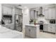 Stylish kitchen boasts stainless steel appliances, gray cabinetry, and white marble countertops at 5278 Walnut Ridge Dr, Orlando, FL 32829