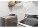 Modern laundry room features Samsung washer/dryer and ample shelf space at 5278 Walnut Ridge Dr, Orlando, FL 32829