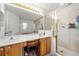 Bathroom featuring double sinks, ample vanity counter space, and a glass-enclosed shower at 5278 Walnut Ridge Dr, Orlando, FL 32829