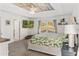 Bright bedroom featuring a ceiling fan, decorative wood ceiling, and a large bed with tropical themed bedding at 5278 Walnut Ridge Dr, Orlando, FL 32829