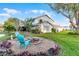 Charming backyard with fire pit and chairs near lush landscape and large tree at 53 Fore Dr, New Smyrna Beach, FL 32168