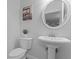 Powder room featuring pedestal sink, round mirror, and neutral paint color at 53 Fore Dr, New Smyrna Beach, FL 32168