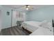 Inviting bedroom with a ceiling fan, light blue walls, and a cozy seating area at 53 Fore Dr, New Smyrna Beach, FL 32168