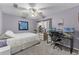 Comfortable bedroom featuring a ceiling fan, desk area, and ample natural light at 53 Fore Dr, New Smyrna Beach, FL 32168