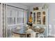 Dining area adjacent to the kitchen, featuring a round wooden table and chairs with a china cabinet at 53 Fore Dr, New Smyrna Beach, FL 32168
