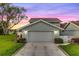 Two-car garage of charming home featuring landscaped yard and well-maintained exterior in a vibrant neighborhood at 53 Fore Dr, New Smyrna Beach, FL 32168