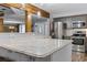 Close-up of the kitchen island, highlighting the granite countertops and stainless steel appliances in the background at 53 Fore Dr, New Smyrna Beach, FL 32168