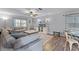 View of living room with hardwood floors and a sectional sofa that leads into a dining area at 53 Fore Dr, New Smyrna Beach, FL 32168