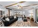 Open floor plan from the living room into the kitchen showcasing the wood beam ceilings and hardwood floors at 53 Fore Dr, New Smyrna Beach, FL 32168