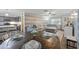 Open-concept living room with a large gray couch, dining table, and modern kitchen with gray cabinets at 53 Fore Dr, New Smyrna Beach, FL 32168