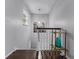 Elegant staircase with dark wood flooring, white banister, and decorative accent table and lighting at 53 Fore Dr, New Smyrna Beach, FL 32168