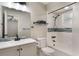 Updated bathroom featuring modern vanity, blue accents, and a shower-tub combo with a tiled backsplash at 655 E Lake View Rd, Lake Alfred, FL 33850
