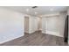 Bedroom featuring hardwood floors, neutral paint, and multiple closets at 655 E Lake View Rd, Lake Alfred, FL 33850