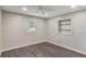 Bedroom featuring gray laminate flooring, a window, and a built-in shelving niche at 655 E Lake View Rd, Lake Alfred, FL 33850