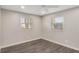 Bedroom with neutral walls, wood-look floors, and bright natural light from large windows at 655 E Lake View Rd, Lake Alfred, FL 33850