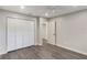 Bedroom featuring wood-look floors, closet, and neutral paint for a calming atmosphere at 655 E Lake View Rd, Lake Alfred, FL 33850