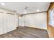 Bedroom showcasing gray flooring, white walls, ceiling fan, and access to a closet at 655 E Lake View Rd, Lake Alfred, FL 33850