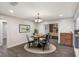 Bright dining room with stylish table setting, modern chandelier, and an open view into the living area at 655 E Lake View Rd, Lake Alfred, FL 33850