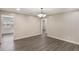 Dining room with a chandelier and hardwood floors that offer an open view and easy access to other rooms at 655 E Lake View Rd, Lake Alfred, FL 33850