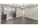 Open dining room showcases updated lighting, a new kitchen with tile backsplash, and hardwood floors at 655 E Lake View Rd, Lake Alfred, FL 33850