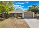 Charming single-story home with stone accents, manicured lawn, and inviting curb appeal under a bright blue sky at 655 E Lake View Rd, Lake Alfred, FL 33850
