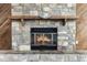 Stone fireplace with rustic wood mantle and decorative hat above a warming fire at 655 E Lake View Rd, Lake Alfred, FL 33850
