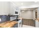 Bright and airy kitchen with butcher block countertops, stainless steel appliances, and plenty of cabinet space at 655 E Lake View Rd, Lake Alfred, FL 33850