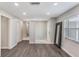 Bright living room features hardwood floors, neutral paint, and natural light from a large window at 655 E Lake View Rd, Lake Alfred, FL 33850
