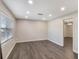 Bright living room featuring luxury vinyl plank flooring, recessed lighting and a large window at 655 E Lake View Rd, Lake Alfred, FL 33850