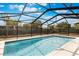 Sparkling pool with screened enclosure, offering a private outdoor retreat with bright blue skies and sunny skies at 655 E Lake View Rd, Lake Alfred, FL 33850