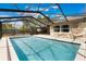 Private pool with screened-in enclosure and patio, offering a serene space for relaxation and recreation at 655 E Lake View Rd, Lake Alfred, FL 33850
