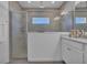 Modern bathroom featuring a walk-in shower with glass enclosure, and a stylish vanity with ample counter space at 7412 Sw 76Th Ter, Ocala, FL 34481