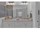 Elegant bathroom with a double sink vanity, large mirror, and modern fixtures, offering a luxurious feel at 7412 Sw 76Th Ter, Ocala, FL 34481