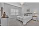 Serene bedroom with neutral decor, large windows, and plush carpeting, creating a peaceful retreat at 7412 Sw 76Th Ter, Ocala, FL 34481