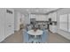 Well-lit open kitchen and dining area featuring sleek white cabinetry and modern appliances, perfect for Gathering meals at 7412 Sw 76Th Ter, Ocala, FL 34481